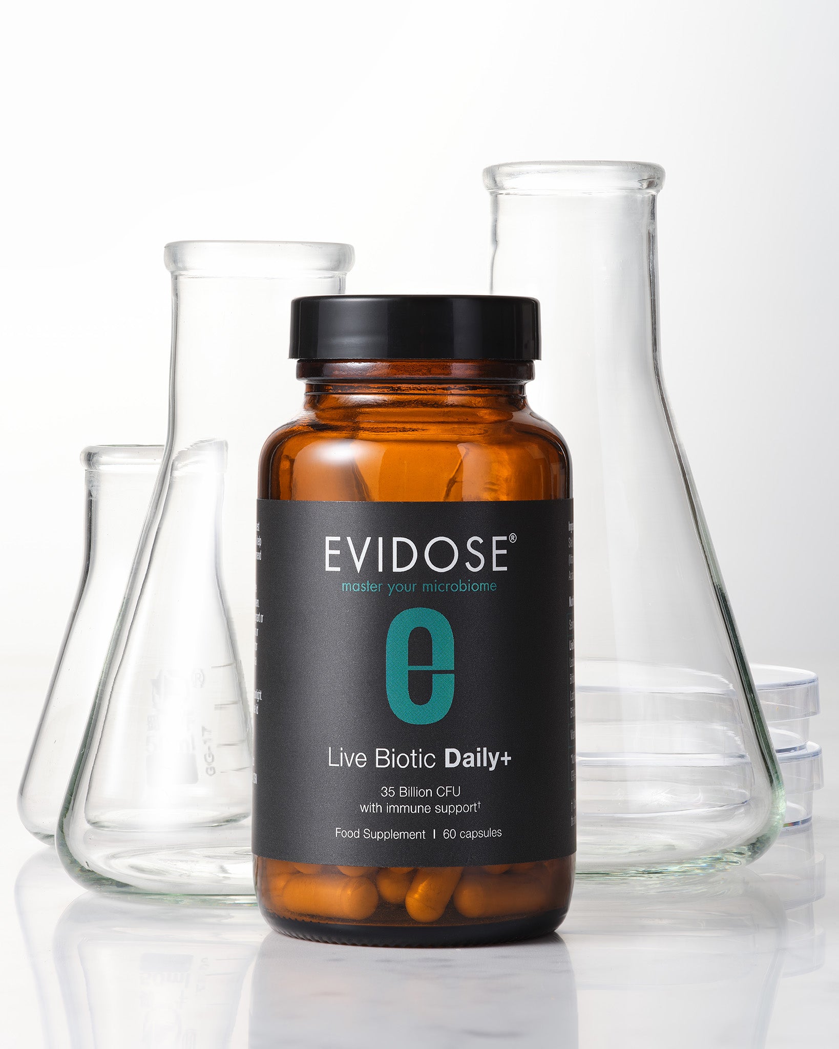 Evidose supplement bottle with glass beakers on a reflective surface